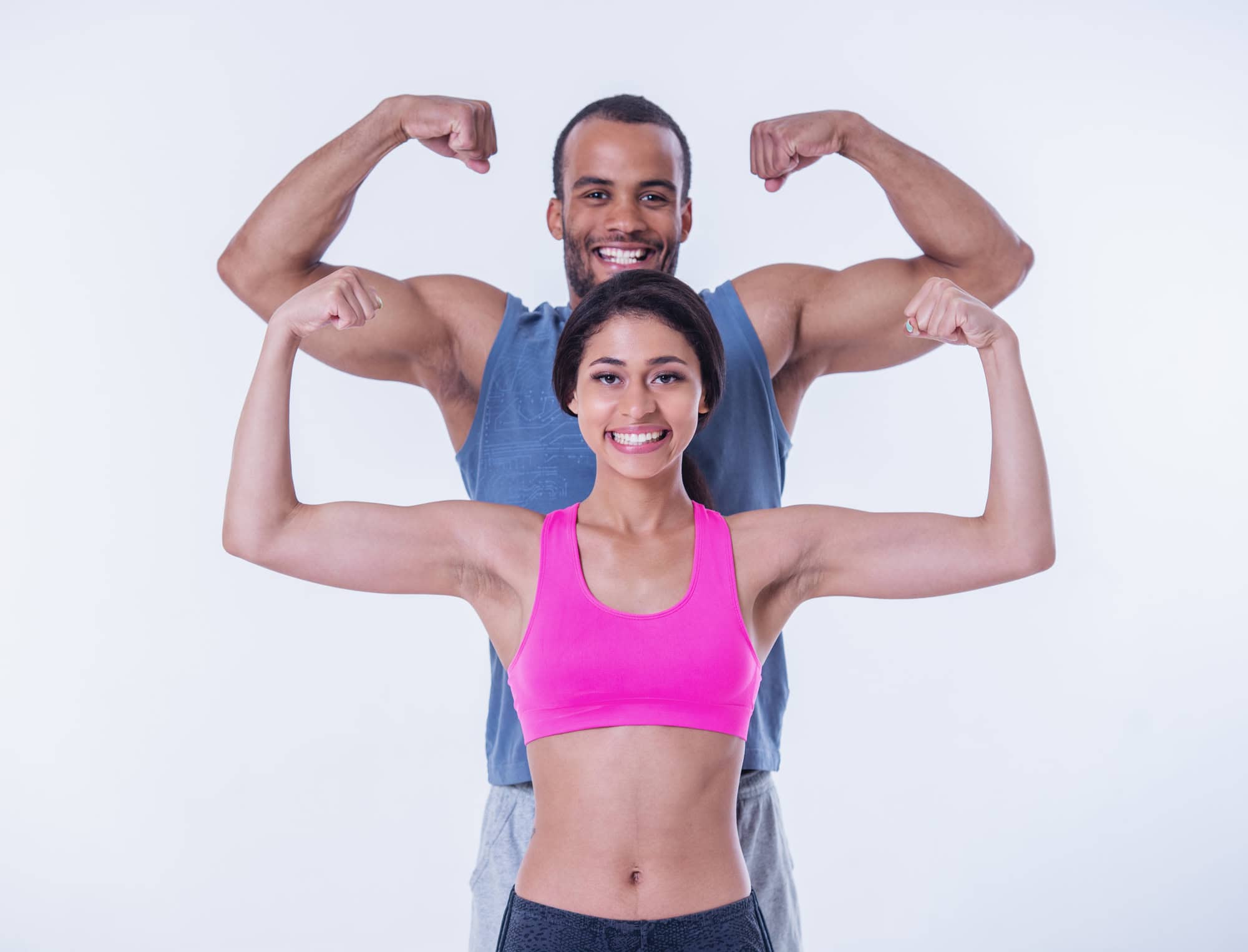 Happy athletic couple flexing muscles, symbolising Ascleus’s impact on strength, recovery, and vitality.
